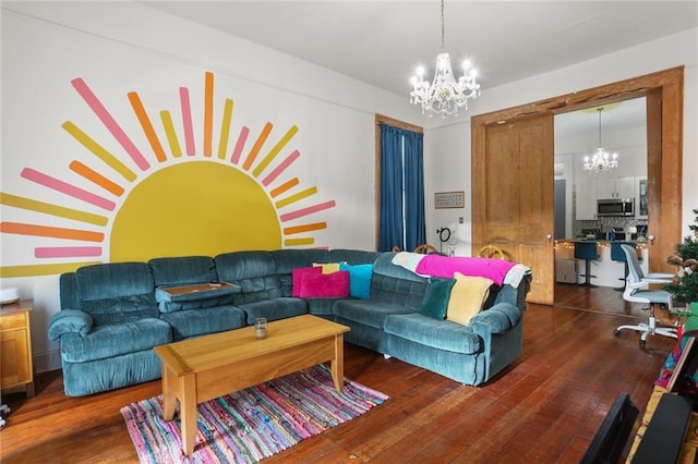 living room with dark hardwood / wood-style floors and a chandelier