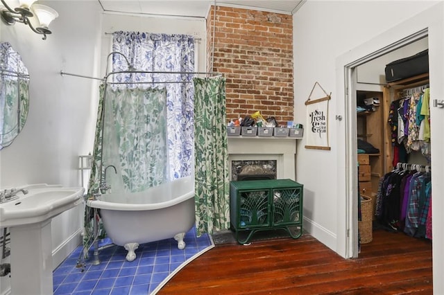 bathroom with a bathtub and hardwood / wood-style flooring