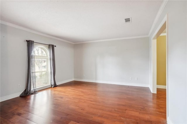 spare room featuring crown molding and dark wood-type flooring