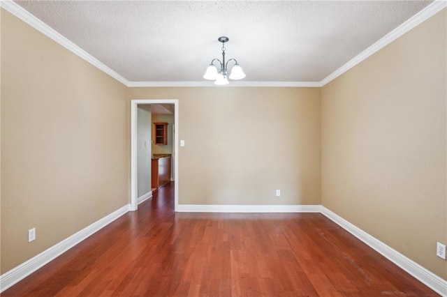 empty room with an inviting chandelier, hardwood / wood-style floors, crown molding, and a textured ceiling