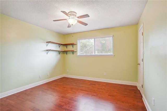 spare room with hardwood / wood-style floors, a textured ceiling, and ceiling fan