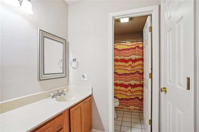 bathroom featuring tile patterned flooring, vanity, and toilet