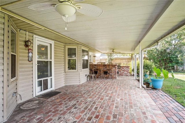 view of patio with ceiling fan and exterior bar