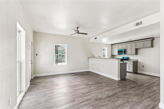 220406 Pauger St, New Orleans, LA 70116 - kitchen featuring stainless steel appliances, gray cabinetry, wood finished floors, a ceiling fan, and baseboards
