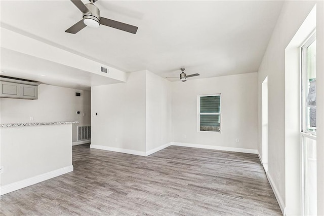 220406 Pauger St, New Orleans, LA 70116 - empty room featuring ceiling fan, light wood-style floors, and baseboards