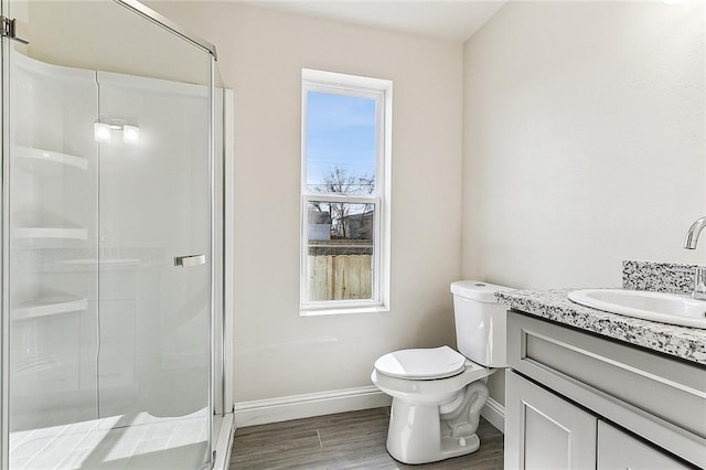 220406 Pauger St, New Orleans, LA 70116 - full bathroom featuring vanity, baseboards, a stall shower, toilet, and wood finished floors