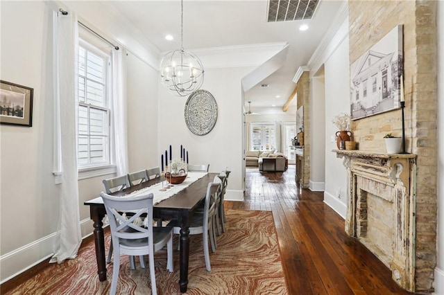 dining area featuring crown molding, plenty of natural light, and dark wood-type flooring