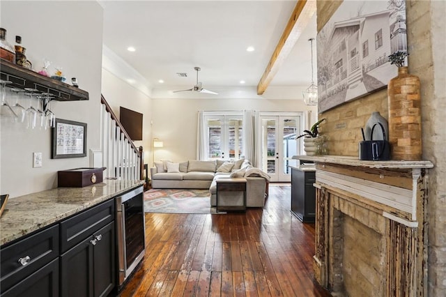 living room featuring wine cooler, dark hardwood / wood-style flooring, ceiling fan, beam ceiling, and french doors