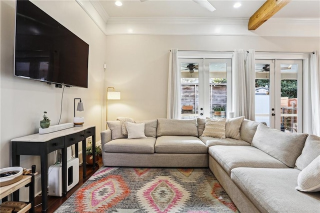 living room with ceiling fan, beam ceiling, dark hardwood / wood-style floors, ornamental molding, and french doors