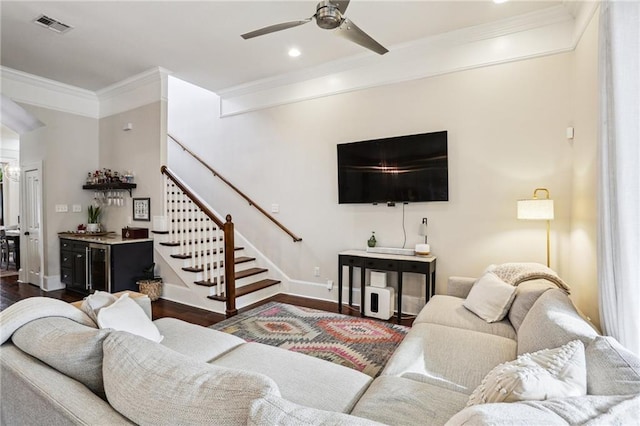 living room with crown molding, bar, ceiling fan, and dark hardwood / wood-style flooring