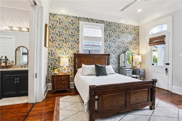 bedroom featuring crown molding, light wood-type flooring, connected bathroom, and ceiling fan