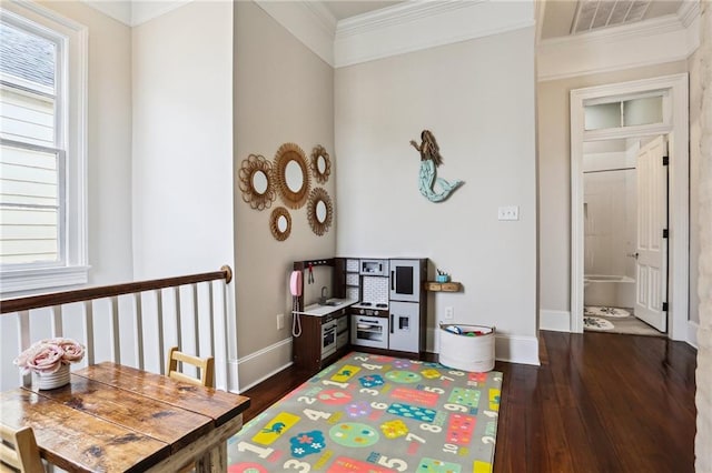 playroom featuring crown molding and dark hardwood / wood-style flooring