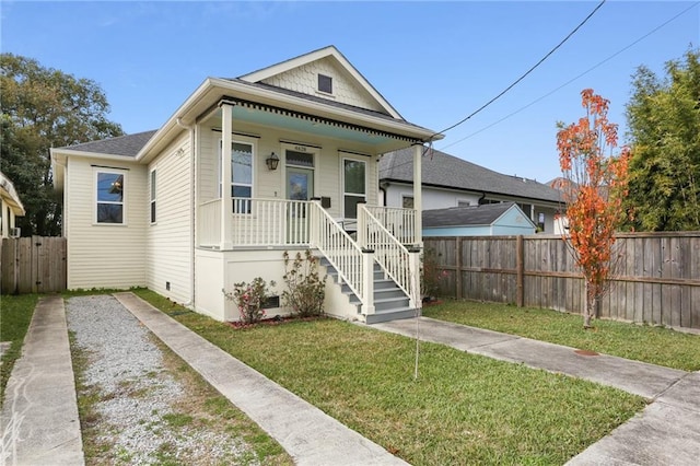 bungalow-style home with covered porch and a front lawn