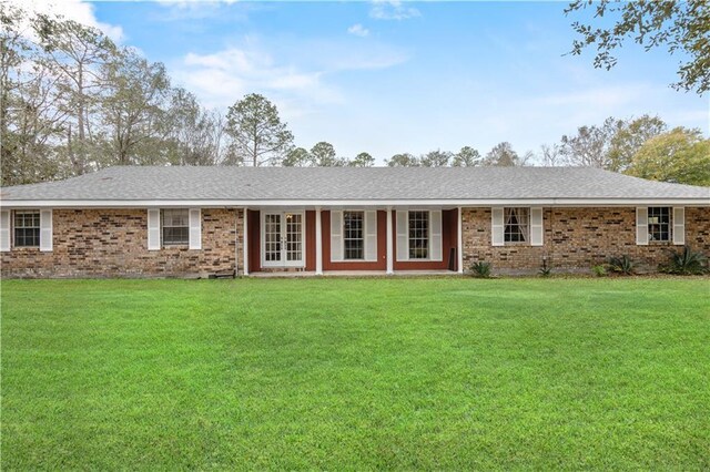 ranch-style home with french doors and a front yard