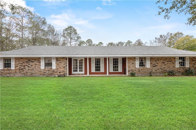 ranch-style home with french doors, brick siding, and a front lawn