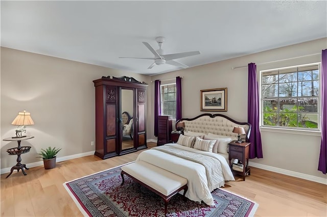 bedroom featuring light wood-style flooring, baseboards, and a ceiling fan