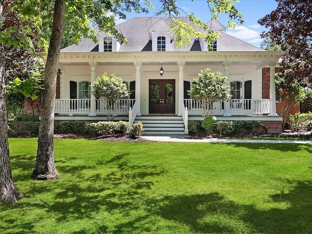 view of front of house with covered porch, french doors, a front lawn, and a shingled roof