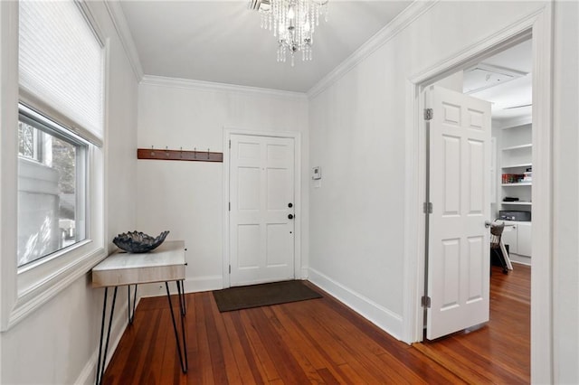 entryway featuring crown molding, an inviting chandelier, and dark hardwood / wood-style flooring