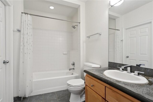 full bathroom with tile patterned flooring, vanity, shower / bathtub combination with curtain, and toilet