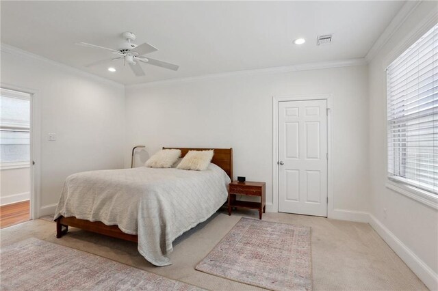 bedroom with multiple windows, ornamental molding, light colored carpet, and ceiling fan