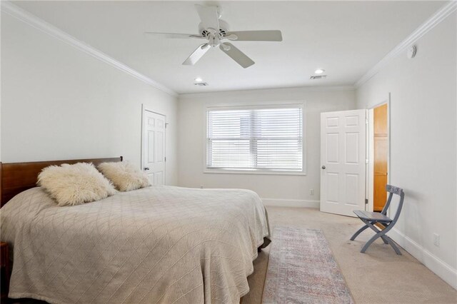 carpeted bedroom with ornamental molding and ceiling fan