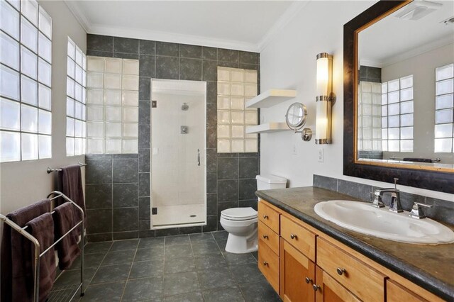 bathroom with tile walls, crown molding, and a healthy amount of sunlight