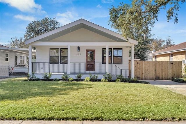 bungalow with a porch and a front lawn