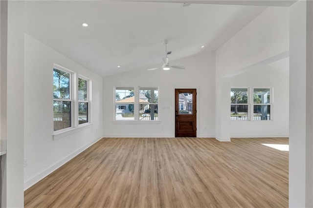 entryway featuring plenty of natural light, high vaulted ceiling, ceiling fan, and light wood-type flooring