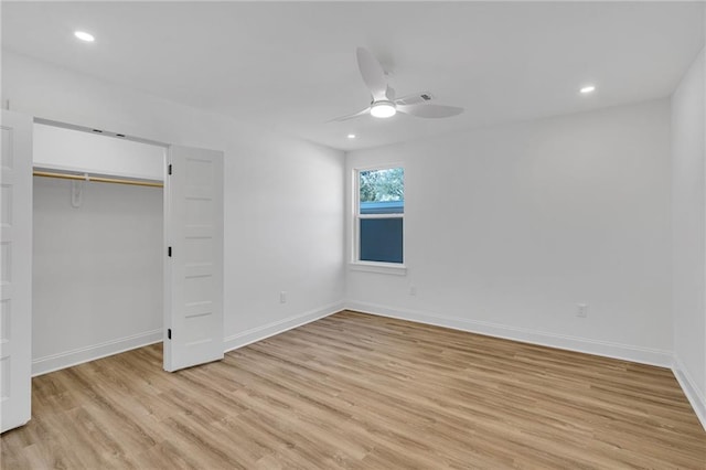 unfurnished bedroom with light hardwood / wood-style flooring, a closet, and ceiling fan