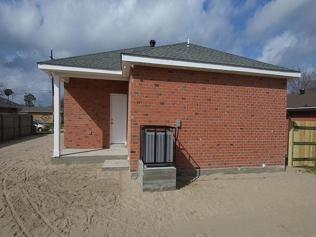 back of property featuring central AC unit