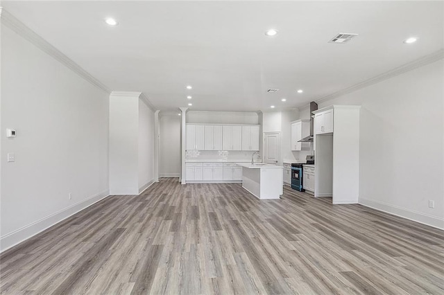 unfurnished living room featuring crown molding, sink, and light hardwood / wood-style flooring