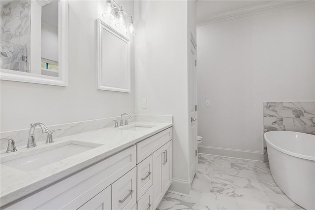 bathroom featuring crown molding, vanity, toilet, and a bathtub