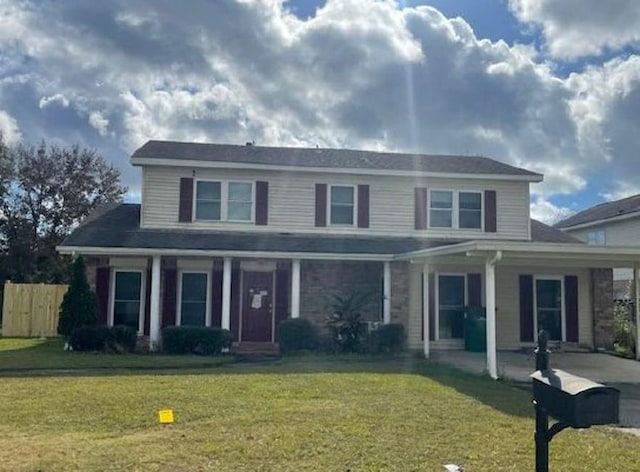 traditional home with a front yard and fence