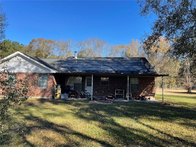 back of house with a yard and a patio