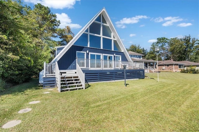 back of property featuring stairway, a yard, board and batten siding, and a wooden deck
