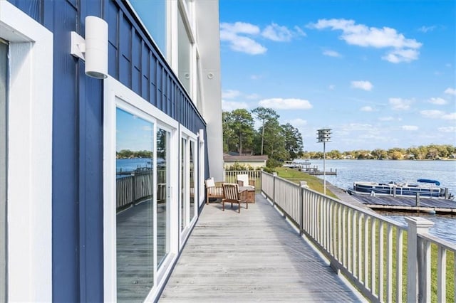 wooden terrace featuring a water view