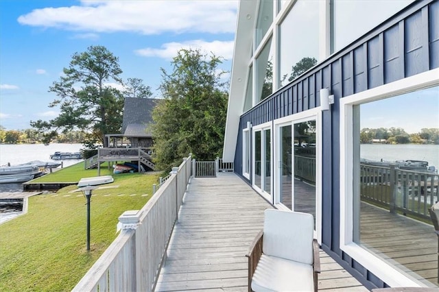 deck featuring a water view and a lawn