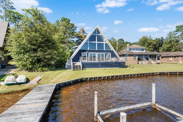 dock area with a yard and a water view
