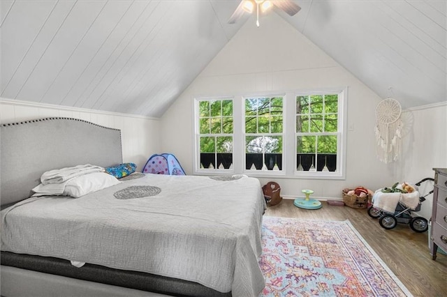 bedroom with vaulted ceiling, a ceiling fan, and wood finished floors
