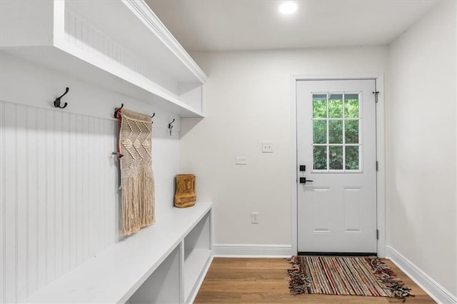 mudroom with wood finished floors and baseboards