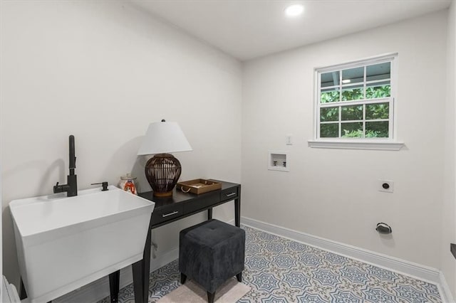 interior space featuring recessed lighting, baseboards, and a sink