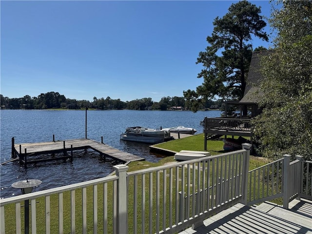 dock area featuring a lawn and a water view
