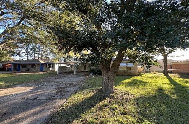 view of front facade with a carport and a front lawn