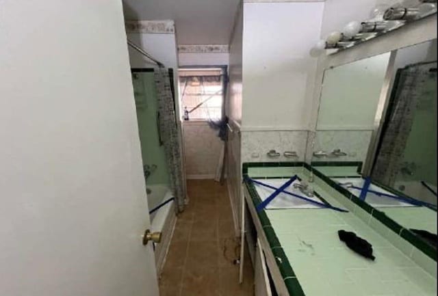 bathroom with tile patterned floors,  shower combination, and vanity