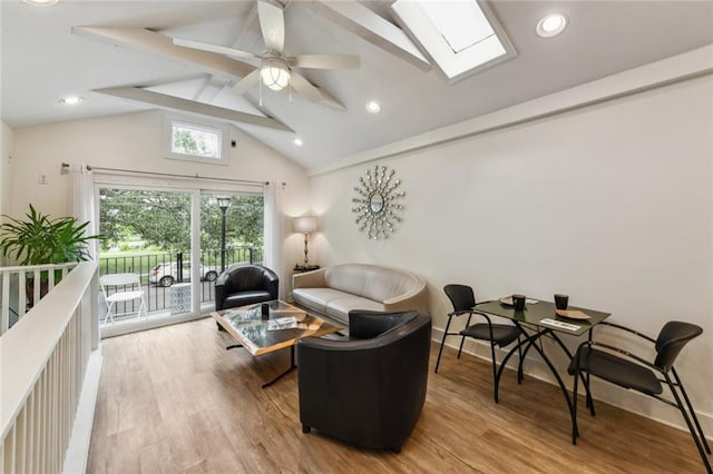 living area with recessed lighting, a skylight, ceiling fan, and wood finished floors