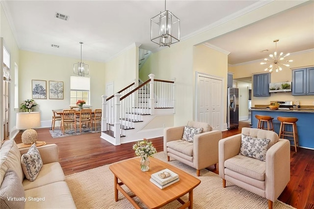 living room with ornamental molding, dark hardwood / wood-style flooring, and a chandelier