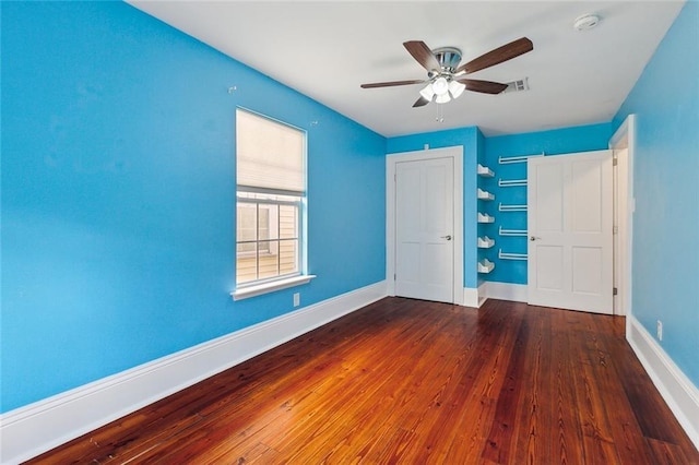 unfurnished bedroom with dark wood-type flooring and ceiling fan