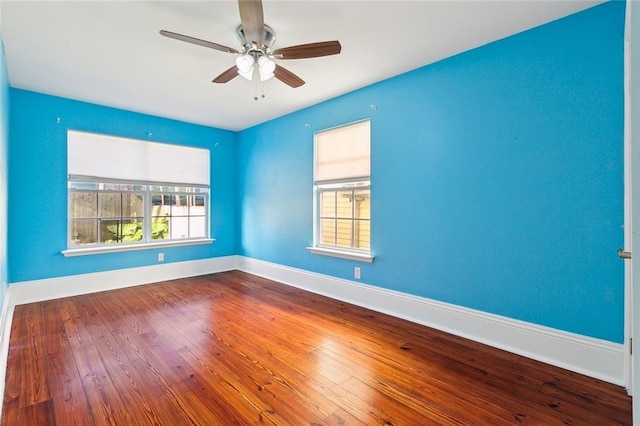 empty room with hardwood / wood-style floors and ceiling fan