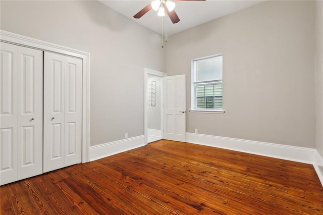 unfurnished bedroom featuring hardwood / wood-style floors, a closet, and ceiling fan