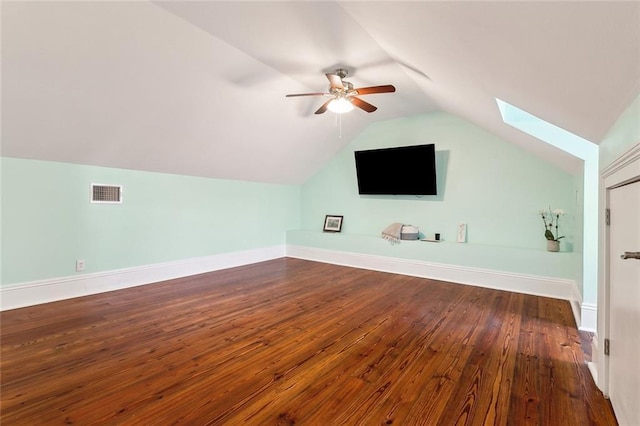 bonus room with hardwood / wood-style floors, vaulted ceiling with skylight, and ceiling fan